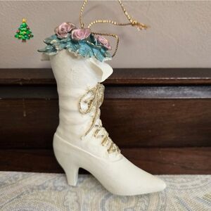 This vintage Christmas ornament is a charming Victorian-style white boot adorned